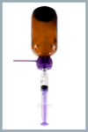 Brown bottle of liquid medicine upside down, with purple bottle adapter and oral syringe attached